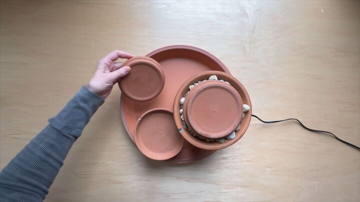 Create a tiered design with the pots and planters