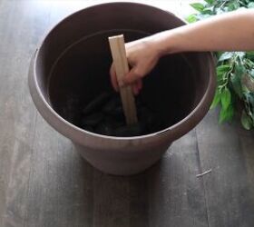 Place a paint stick in the planter for support