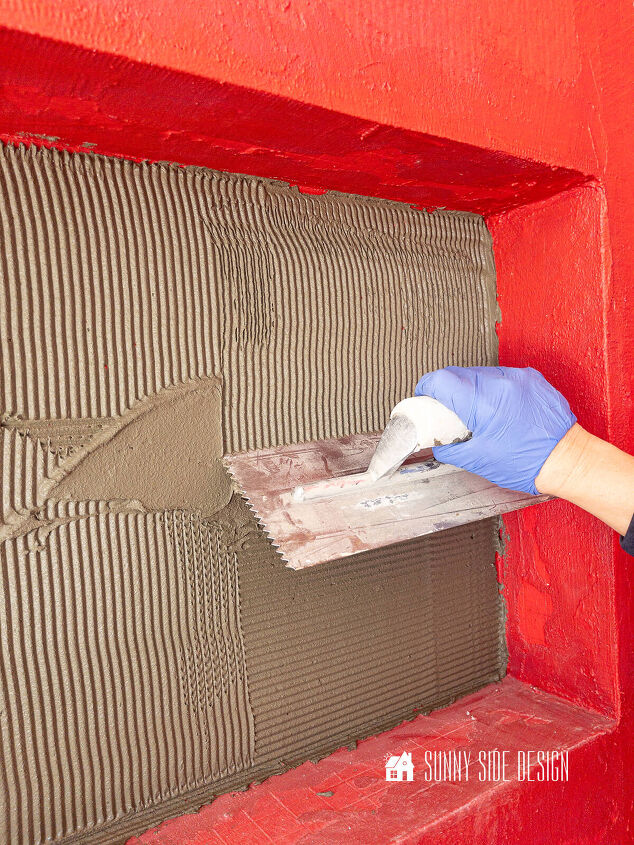 Trowel mortar into back of shower niche