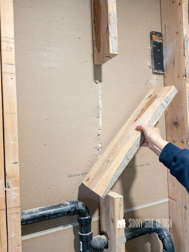 A section of the 2x6 wall is removed to allow for a larger niche in the shower