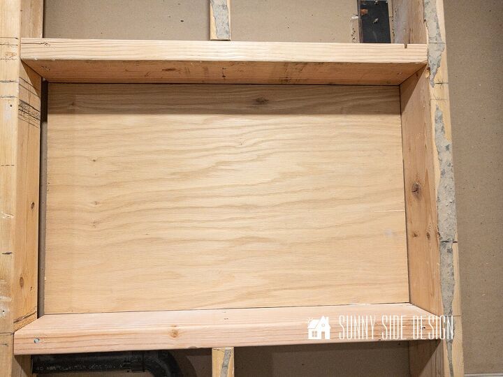 Framed out area with a plywood backing for the bathroom niche