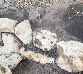 Second row of rocks are placed and fill dirt is added to stabilize this row of the retaining wall