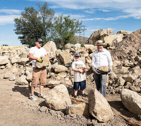 Two men and a young boy carry stones at a rock quarry