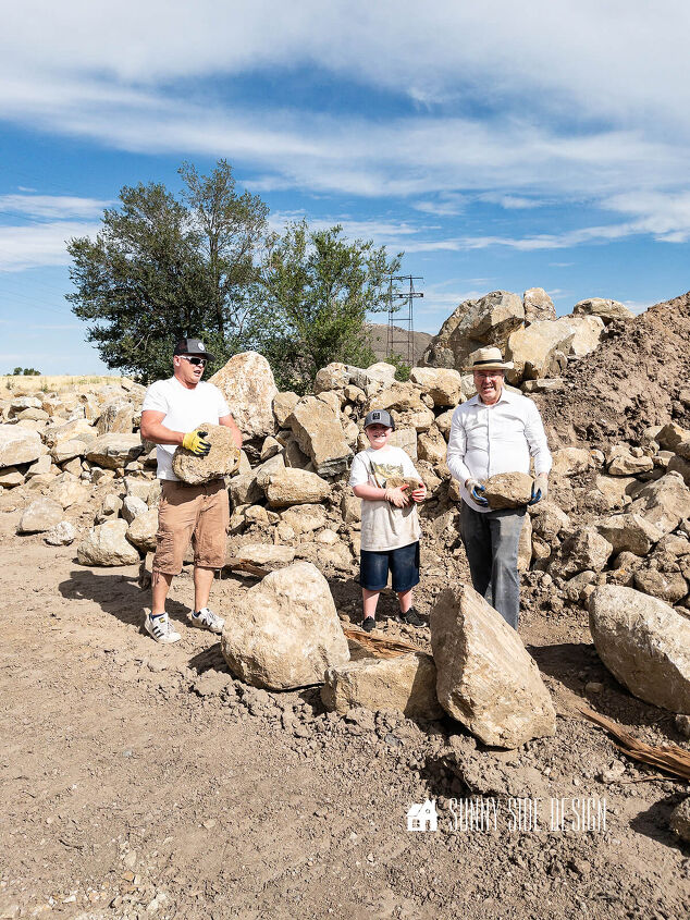 Two men and a young boy carry stones at a rock quarry
