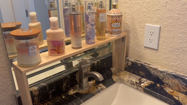 The finished bathroom sink shelf with organized bathroom essentials