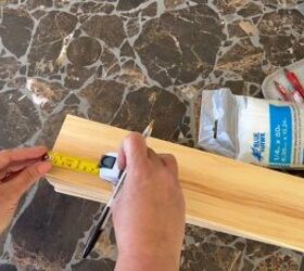Measuring the wood with a tape measure