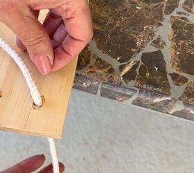 Sliding rope through the holes and tying a knot