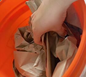 She stuffs packing paper into a Home Depot bucket for the best Father's Day idea ever