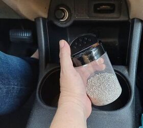 Container filled with cat litter placed in cup holder