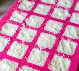 homemade dishwasher detergent tablets with essential oils, putting dishwash mixture into silicone mold
