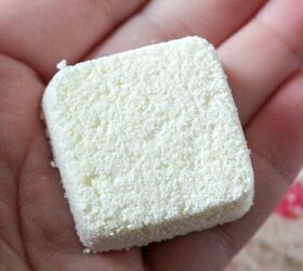 homemade dishwasher detergent tablets with essential oils, finished dishwasher tab holding in the palm of hand