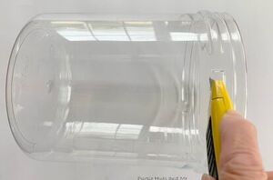 She slices up a plastic container for this pretty and clever storage hack