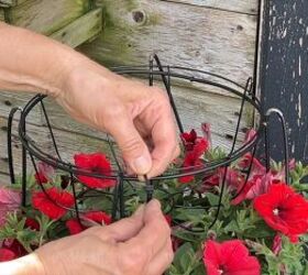 Securing the top basket to complete the 3-tiered tomato cage planter