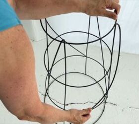 She bends down the legs of her tomato cage and puts it on her porch for a gorgeous idea