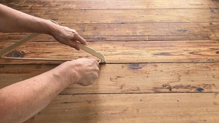 Removing the wooden bars from the hangers for our diy side table project