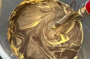 She mixes paint together for this pretty decor accent