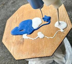 She pours 2 bottles of paint on this little old table for this easy and fun 1-hour idea