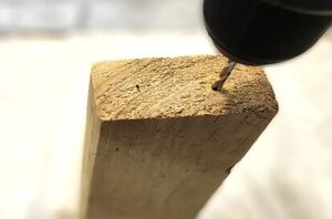 Drill 2 holes in a piece of scrap wood for this super cute holiday idea