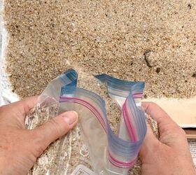 She pours sand in a Ziploc bag for this coastal decor idea
