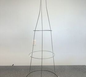 She bends down the legs of her tomato cage and puts it on her porch for a clever idea