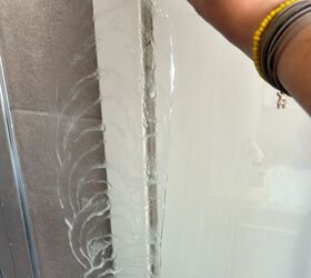 No more hard water spots—this homemade shower glass cleaner leaves doors gleaming