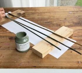 Painting bamboo stakes green to resemble flower stems