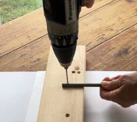 Drilling holes into the bamboo stakes for attaching wire alliums