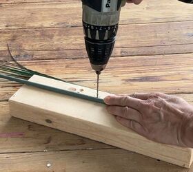 Drilling small holes in the bamboo stakes for the faux grass leaves