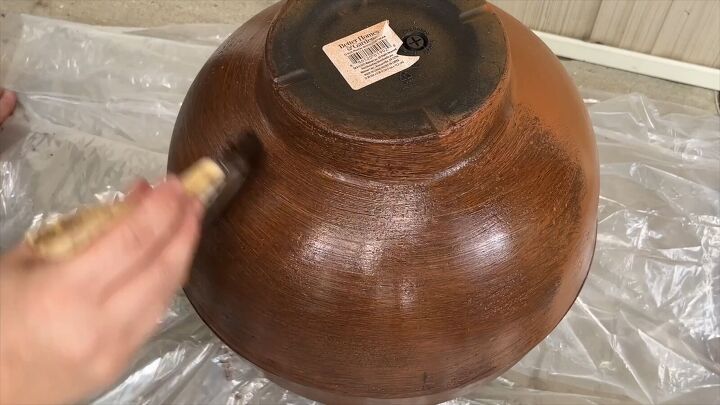 Applying gel stain to the planters to create a faux wood effect