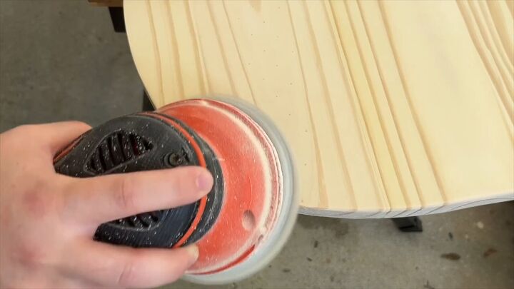 Sanding the edges of the board with an orbital sander