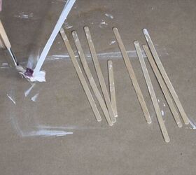 Wood stir sticks being painted white