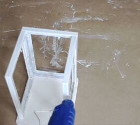 Frames being attached to the wooden base with hot glue