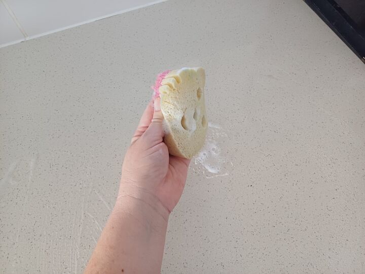 Sponge being used to scrub a countertop
