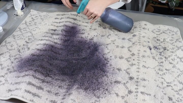 Spraying dye onto the rug