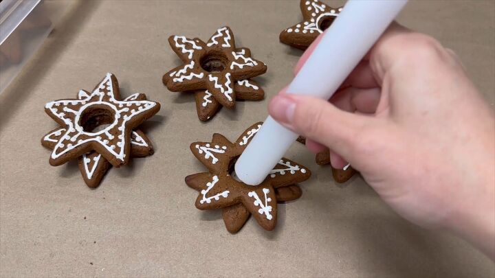 Inserting a candle to complete the Christmas cookie candle