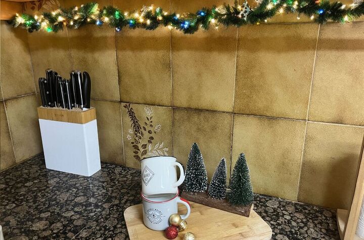 Green garland and gold ribbon add a cozy holiday glow.