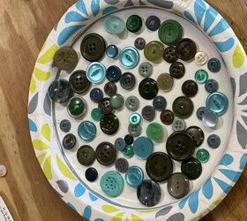She puts a bunch of buttons on a paper plate for this adorable little idea
