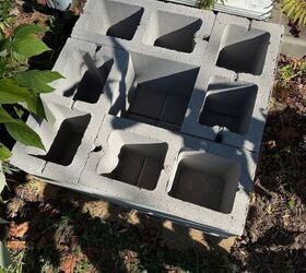 He lays 4 cinder blocks right next to his house for a clever way to save money