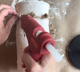 She glues knotted jute twine around a plain glass vase for this stunning Anthropology-inspired idea