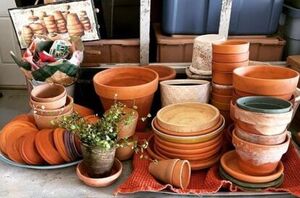 She grabs all of her terracotta flower pots for this ridiculously cute idea