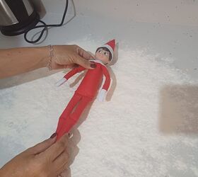 Position your elf in the middle of the flour for their snow angel debut