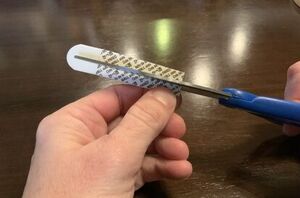 She cuts a Command strip in half for this genius last-minute holiday decor idea
