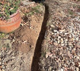 Dig a trench under your downspout for this brilliant front yard idea