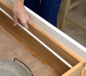 The clever reason she presses a tension rod into her kitchen drawer