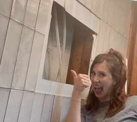 She breaks a hole in the wall above her bathtub for this brilliant trick