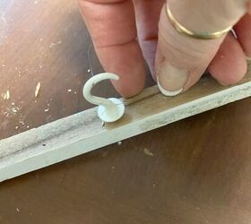 She stuck cup hooks under her mantel for the easiest decorating shortcut (perfect for this week!)