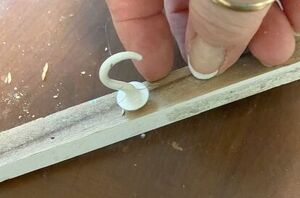 She stuck cup hooks under her mantel for the easiest decorating shortcut (perfect for this week!)