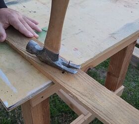 Breaking down pallet wood for a budget-friendly project.