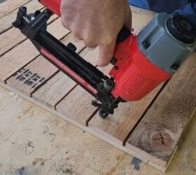 Using a nail gun to secure each board for a strong hold