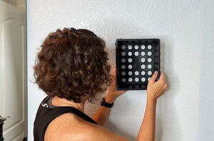 She holds a Dollar Tree crate on her wall for this brilliant idea